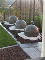 A set of (2)...24'' concrete spheres